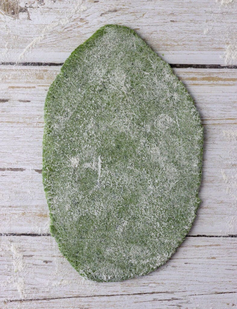 pasta dough rolled out enough to fit the first setting on the pasta maker machine